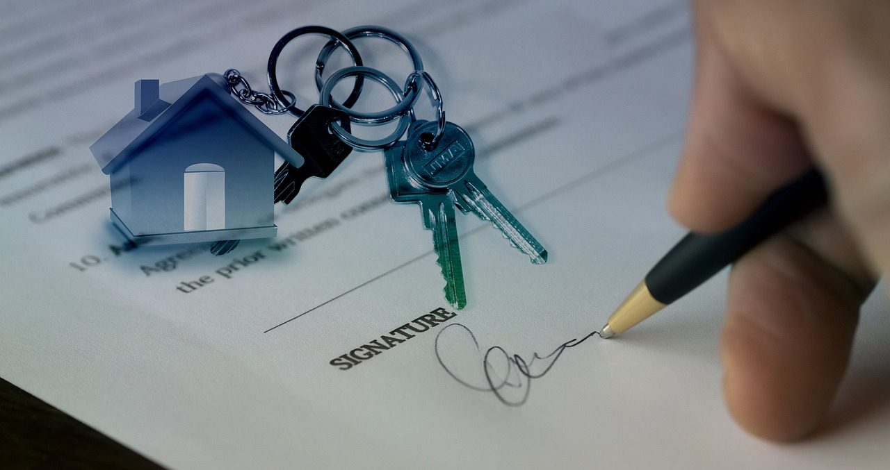 one party is signing an agreement regarding selling a home during a divorce